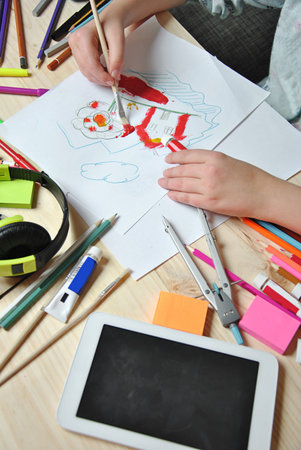 hands of girl painting a picture on your desktop
