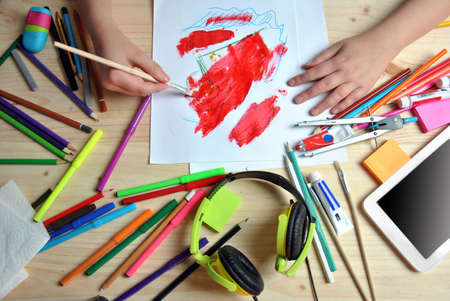 hands of girl painting a picture on your desktopの写真素材