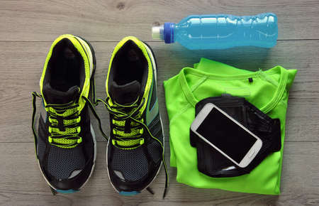 Clothes make running with isotonic drink, phone and T-shirtの写真素材