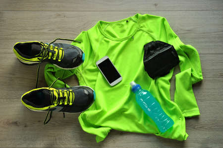 Clothes make running with isotonic drink, phone and T-shirt