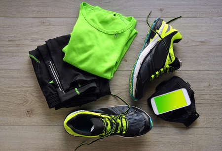 Clothes make running with isotonic drink, phone and T-shirtの写真素材