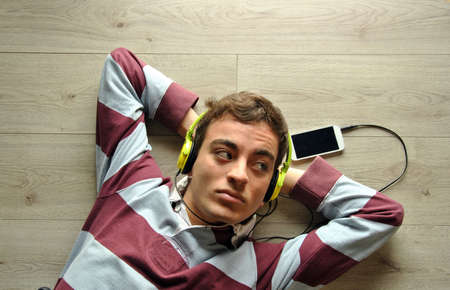 Young man listening to music with mobilの写真素材