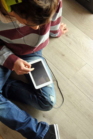 Young man listening to music with mobilの写真素材