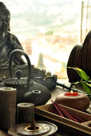 VARIOUS TYPES OF INCENSE WITH TEAPOT AND BUDDHA STATUEの写真素材