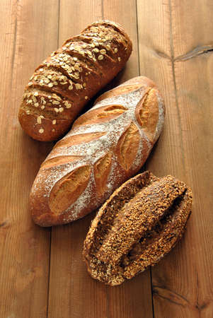 Different types of bread on a wooden tableの写真素材