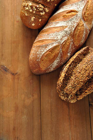 Different types of bread on a wooden tableの写真素材