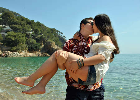 couple on the seashore enjoying the holidaysの写真素材