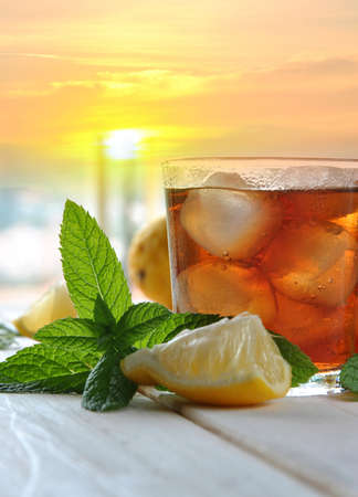 glasses of ice tea with mint leaf on wooden tableの写真素材