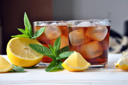 glasses of ice tea with mint leaf on wooden tableの写真素材