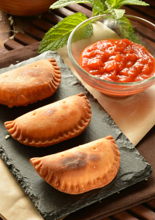 homemade tuna patty with tomato sauce on wooden tableの写真素材