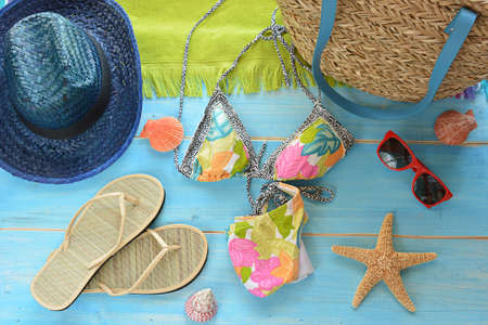 accessories to go to the beach as slippers, bag and swimsuitの写真素材