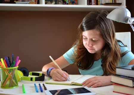 girl studying at her desk using a tabletの写真素材