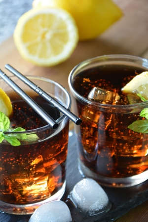 two glasses of Cuba Libre cocktail with lemon and mintの写真素材