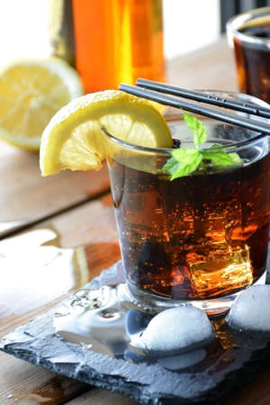 two glasses of Cuba Libre cocktail with lemon and mintの写真素材