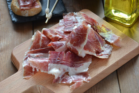 appetizer of ham Serrano with bread roasted and accompanied by a glass of wine