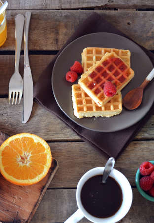 plate of waffles with raspberry marmalade, orange juice and coffeeの写真素材