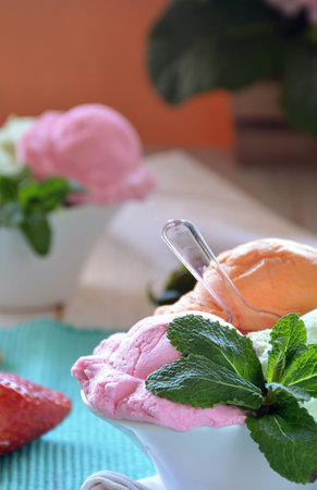 ice cream of various flavors, accompanied by Mint, Tangerine and strawberriesの写真素材