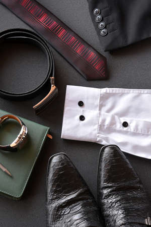 men's clothing along with several accessories such as clock, calendar, belt and shoesの写真素材