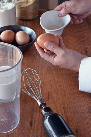 CHEF PREPARING A CAKE WITH FLOUR, MILK AND EGGS