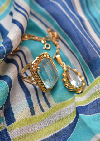 ring and necklace golden accompanied by a precious stoneの写真素材