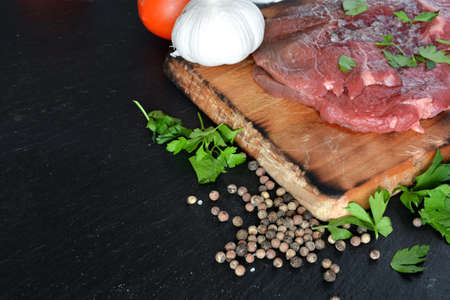 dish with raw meat with salt, oil and parsleyの写真素材