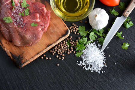 dish with raw meat with salt, oil and parsleyの写真素材