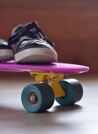 skateboard with bag, sneakers and mobile phoneの写真素材