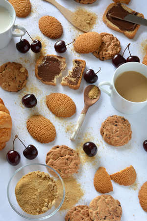 Few chocolate cookies and biscuits with milk and coffee for breakfastの写真素材