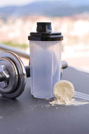 Whey protein taste vanilla and chocolate, dumbbell back to start trainingの写真素材