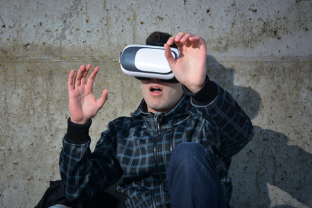 Teen playing with glasses of reality virtual in the street