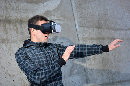 Teen playing with glasses of reality virtual in the street