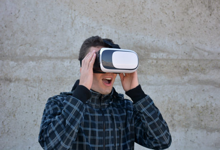 Teen playing with glasses of reality virtual in the street