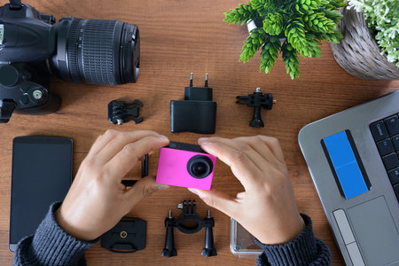 Camera's action with their accessories accompanied of a notebook and a camera reflexの写真素材