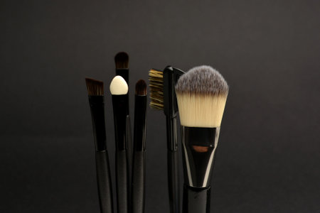 makeup tools and powder makeup on black backgroundの写真素材