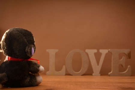 Teddy bear with LOVE wood and a gift for Valentine Day lyricsの写真素材