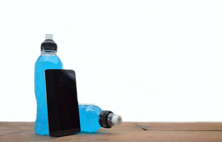 sports drink on wooden table and white backgroundの写真素材