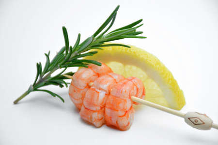 Prawns accompanied of lemon and Rosemary on background whiteの写真素材