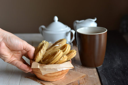 Churros accompanied of a cup of chocolate hot and sugarの写真素材