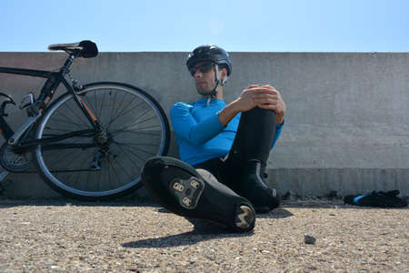 cyclist training on a lonely road during the dayの写真素材