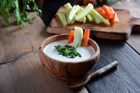 Homemade Tsatsiki sauce served with carrot and cucumberの写真素材