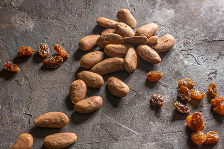 Almond with raisins in a dish of wood with oatmealの写真素材