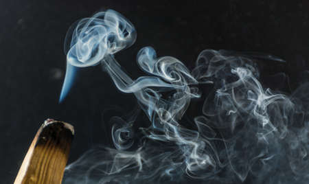 photograph of smoke caused by various incenses on black backgroundの写真素材
