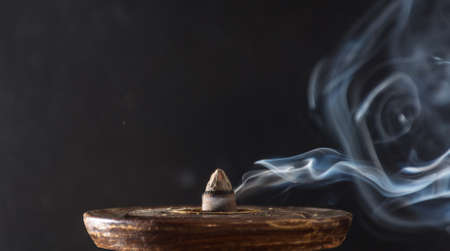 photograph of smoke caused by various incenses on black backgroundの写真素材