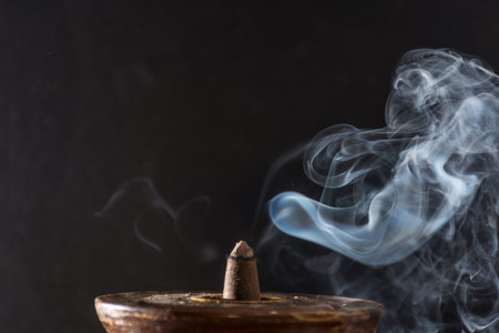 photograph of smoke caused by various incenses on black background