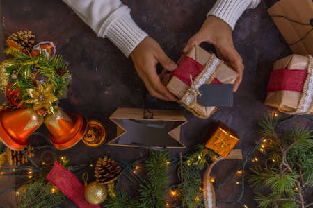 overhead photograph of hands wrapping Christmas giftsの写真素材