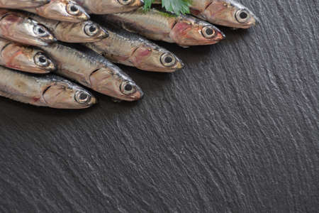 Fresh anchovies ready to Cook, accompanied by lemon, garlic and parsleyの写真素材