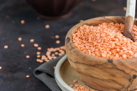 Wooden Bowl full of red lentils. Perfect food for vegetariansの写真素材