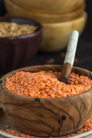 Wooden Bowl full of red lentils. Perfect food for vegetariansの写真素材