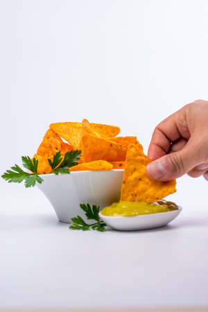 Plate full of nachos with guacamole on a white backgroundの写真素材