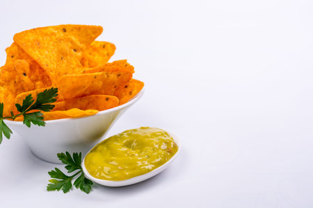 Plate full of nachos with guacamole on a white backgroundの写真素材